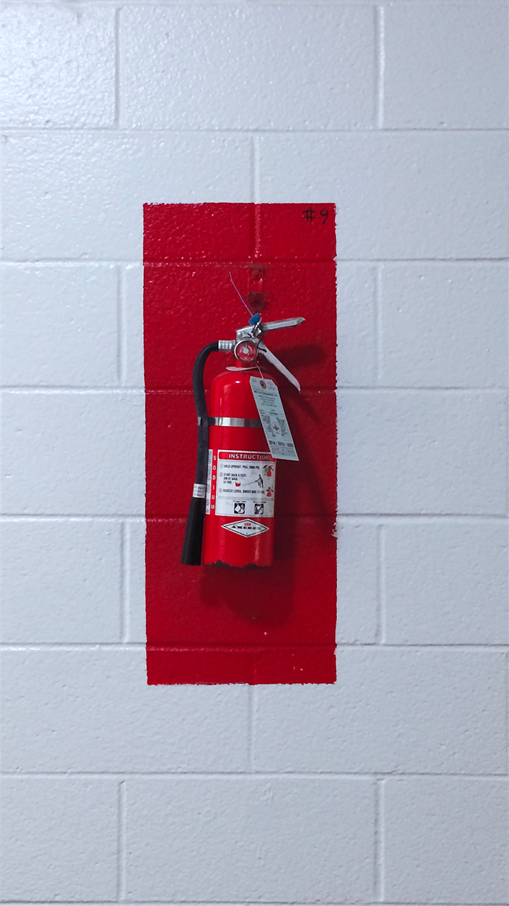 Fire extinguisher on concrete walls